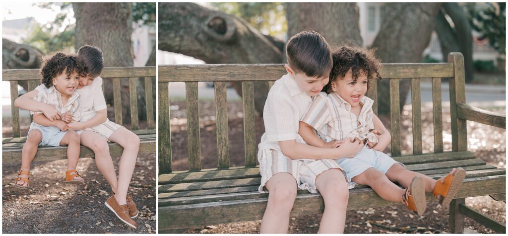 two brothers sitting on a bench laughing together