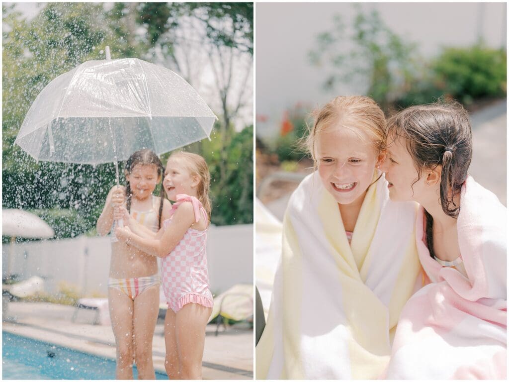 Two little girls play in the sprinkler and giggle together while wrapped in colorful towels. 